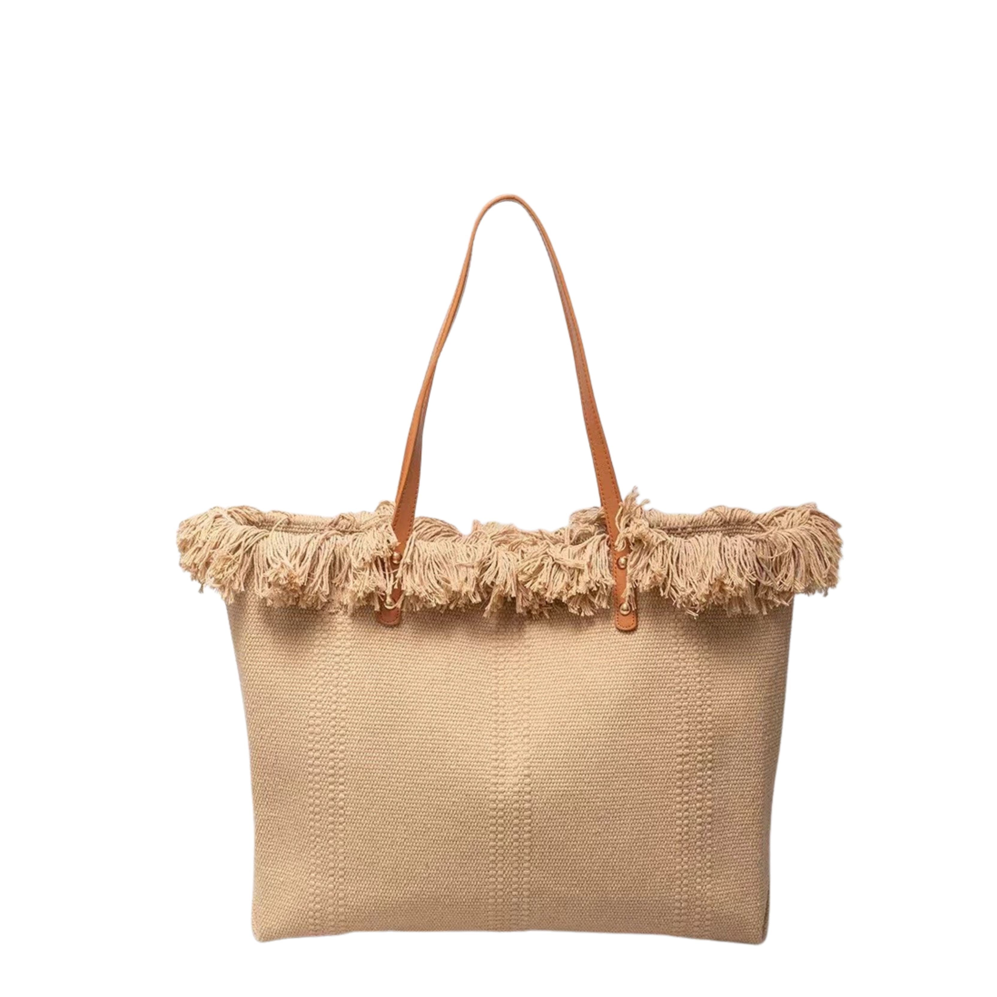Beige woven handbag with frayed edge and brown leather handle on a white background
