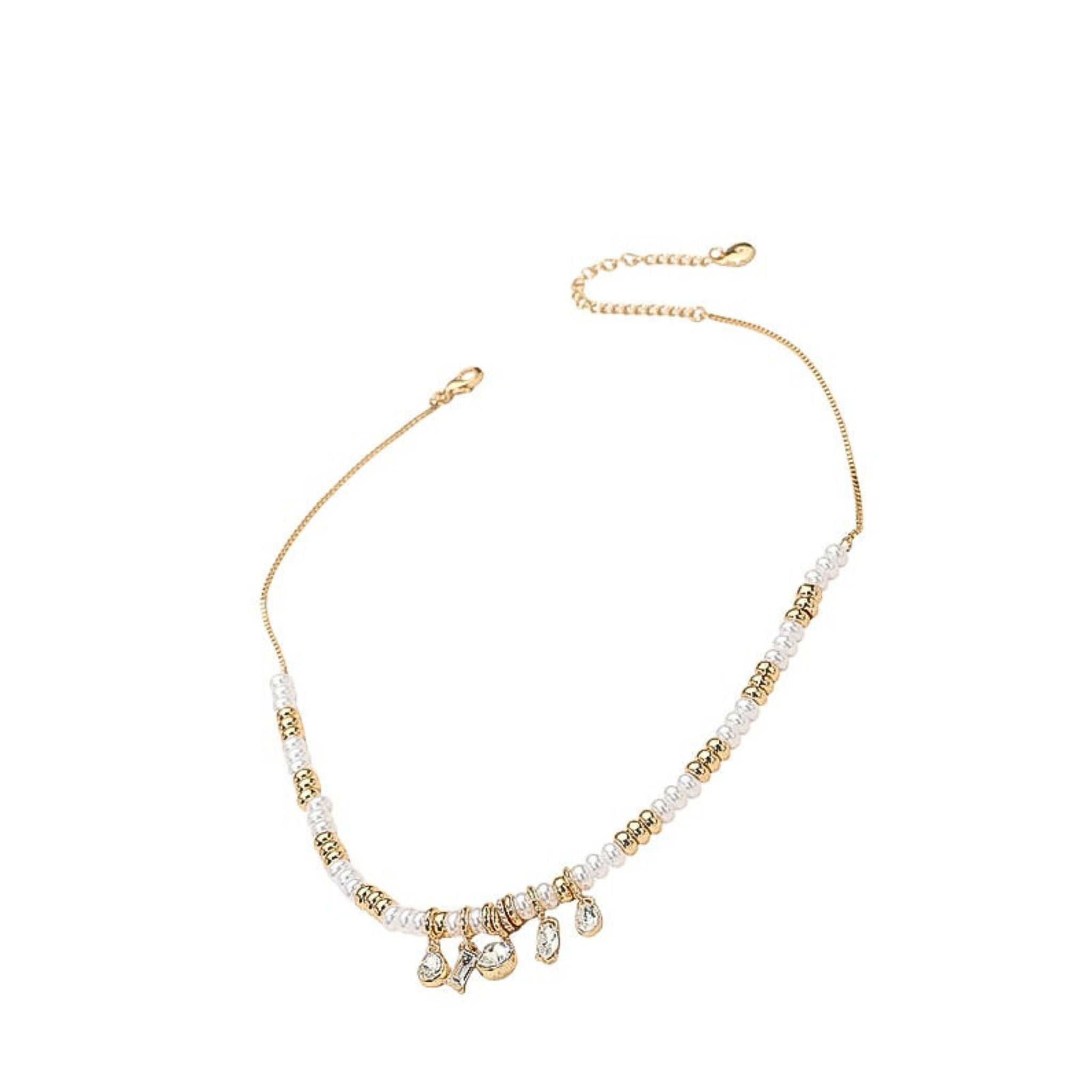 Gold and pearl necklace on a white background