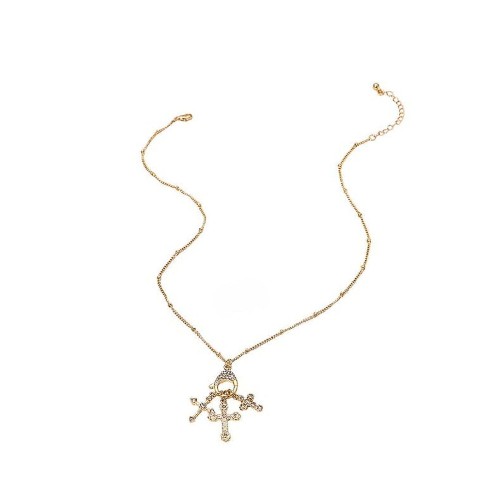 Gold necklace with a cross pendant on a white background