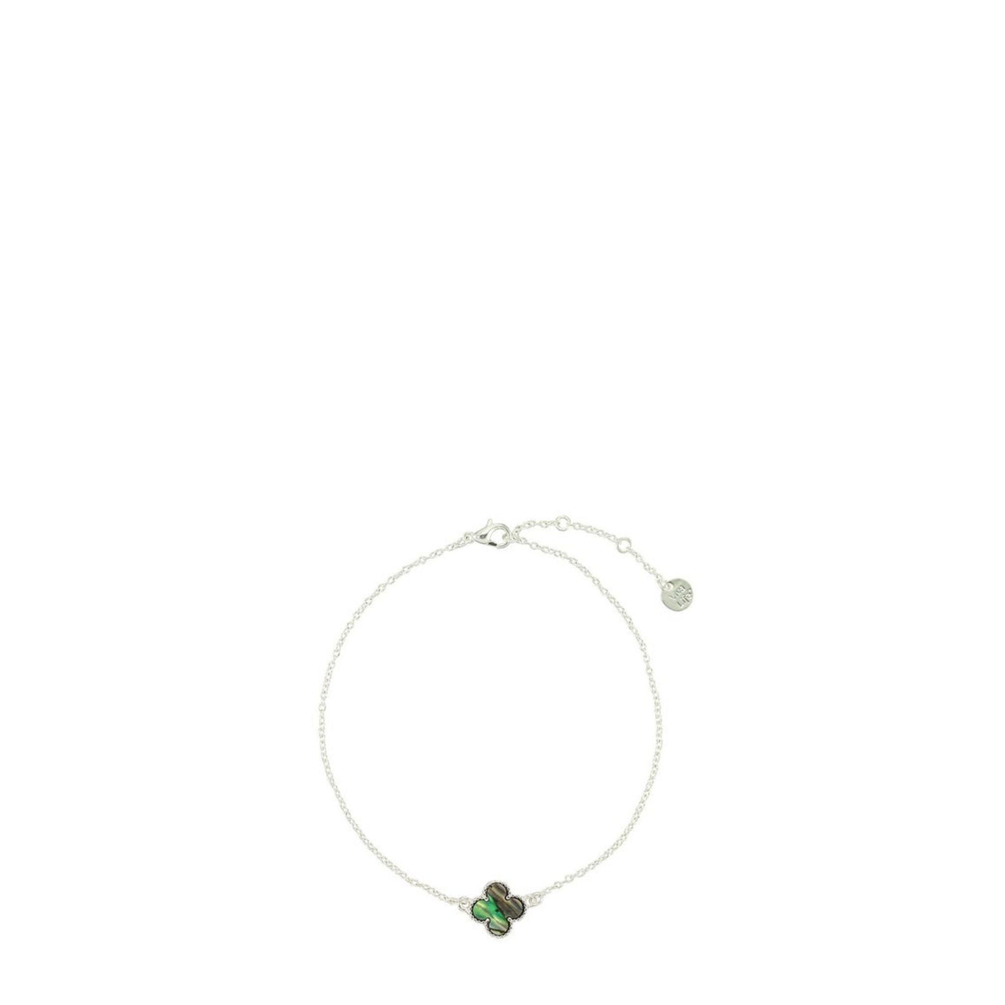 Silver bracelet with green stones on a white background