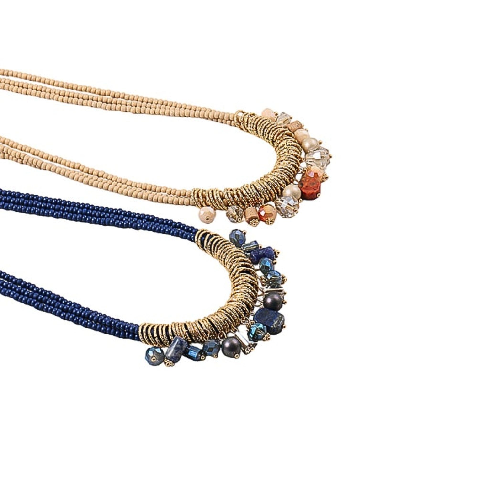 Two beaded necklaces, one blue and one beige, with decorative elements on a white background.