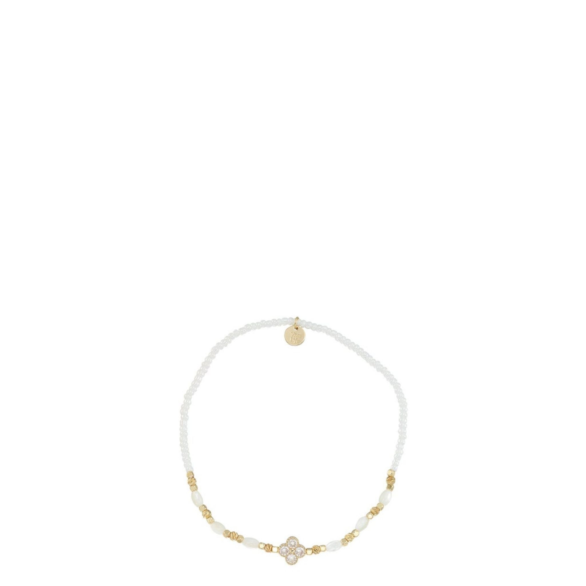 White beaded headband with gold accents on a white background