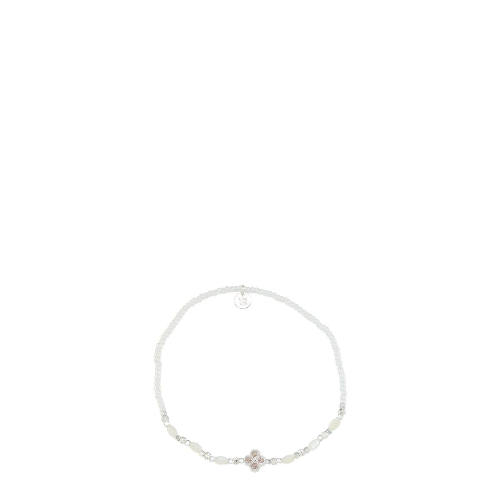 Silver bracelet with a small pink flower charm on a white background