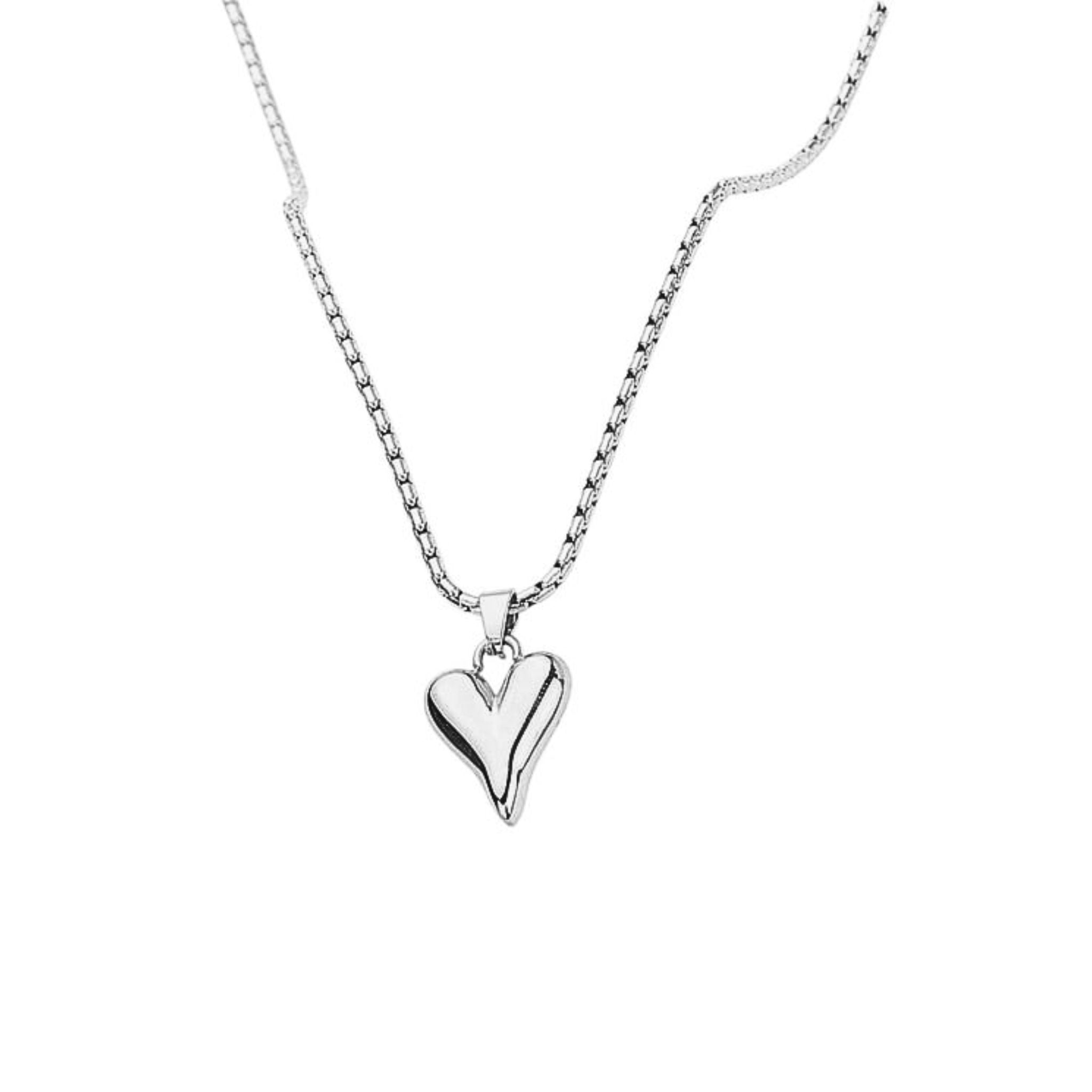 Silver heart-shaped pendant on a chain against a white background