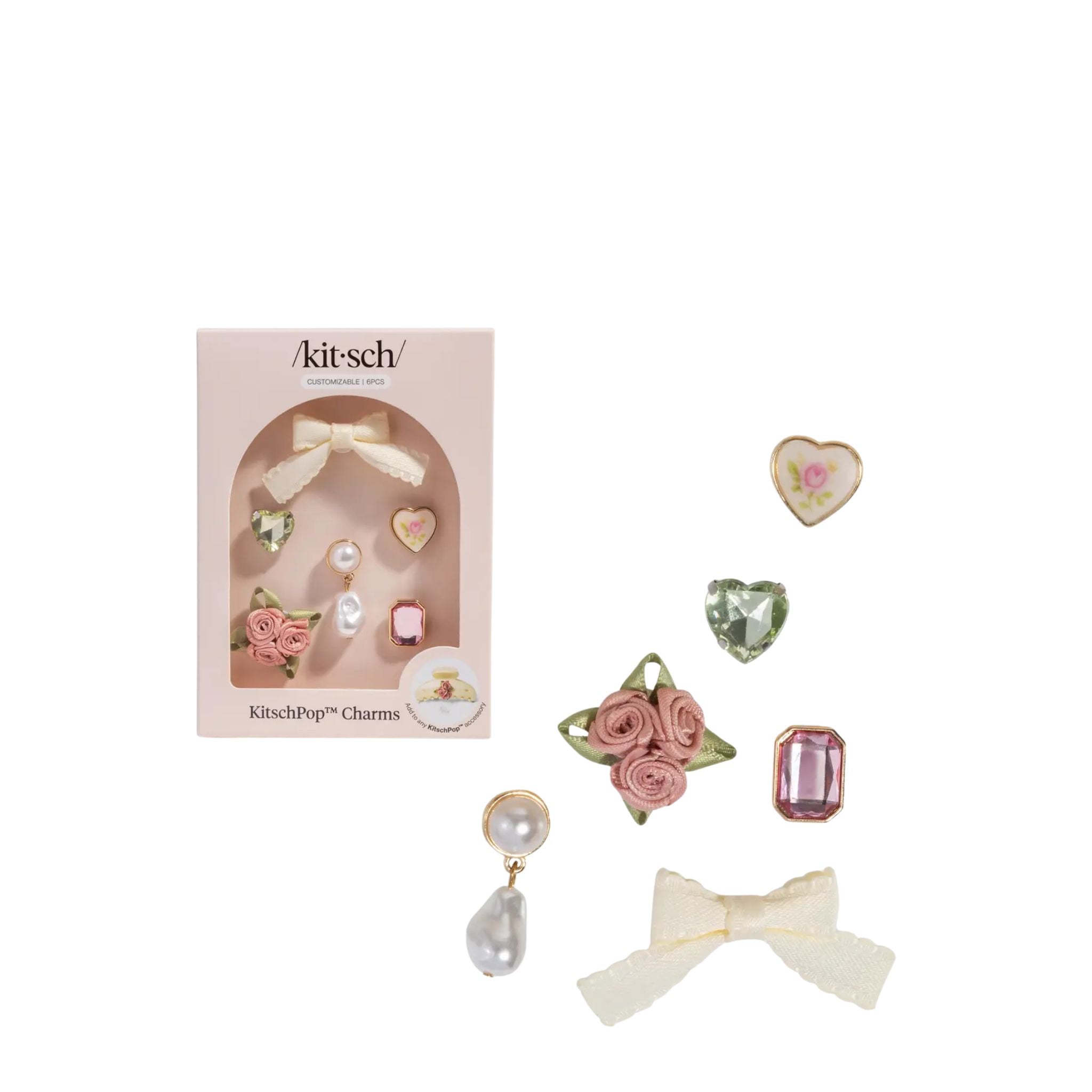 Kitsch charm set with decorative items and packaging on a white background