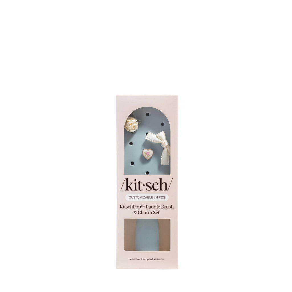 Kitsch paddle brush and charm set packaging on a white background