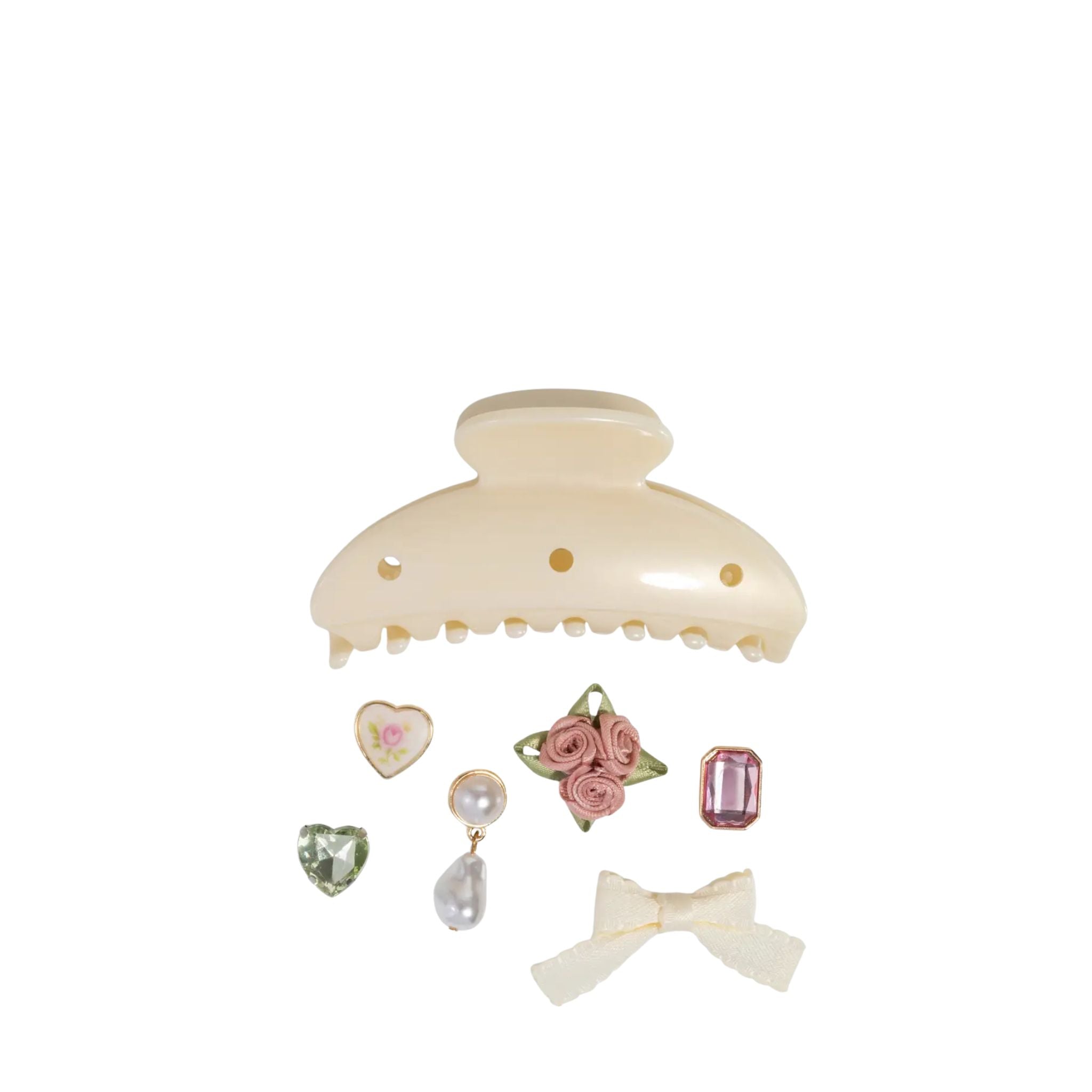 Cream-colored hair clip with decorative pins on a white background
