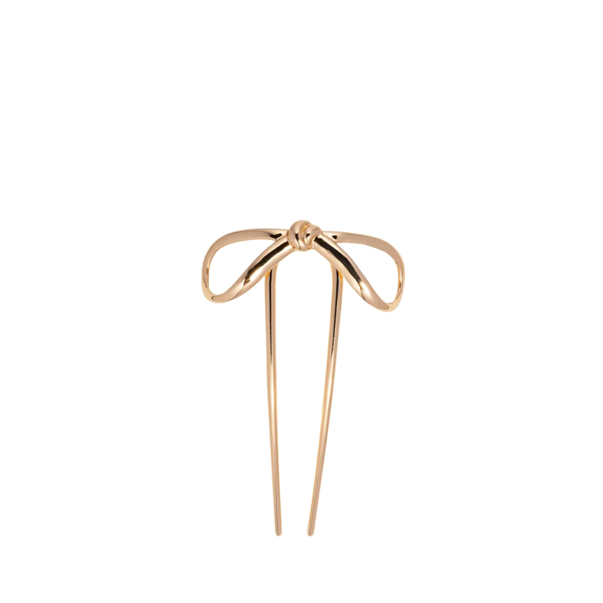 Gold bow-shaped hairpin on a white background