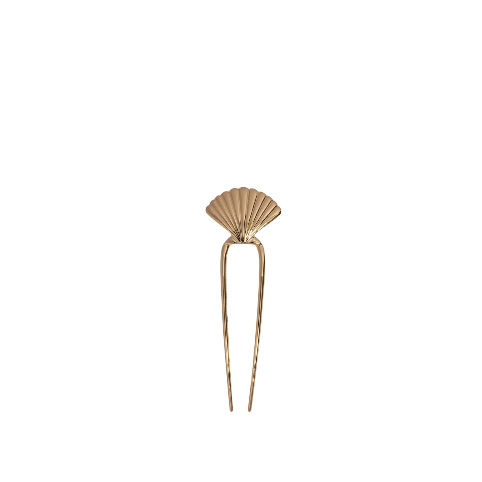 Gold hairpin with shell design on a white background