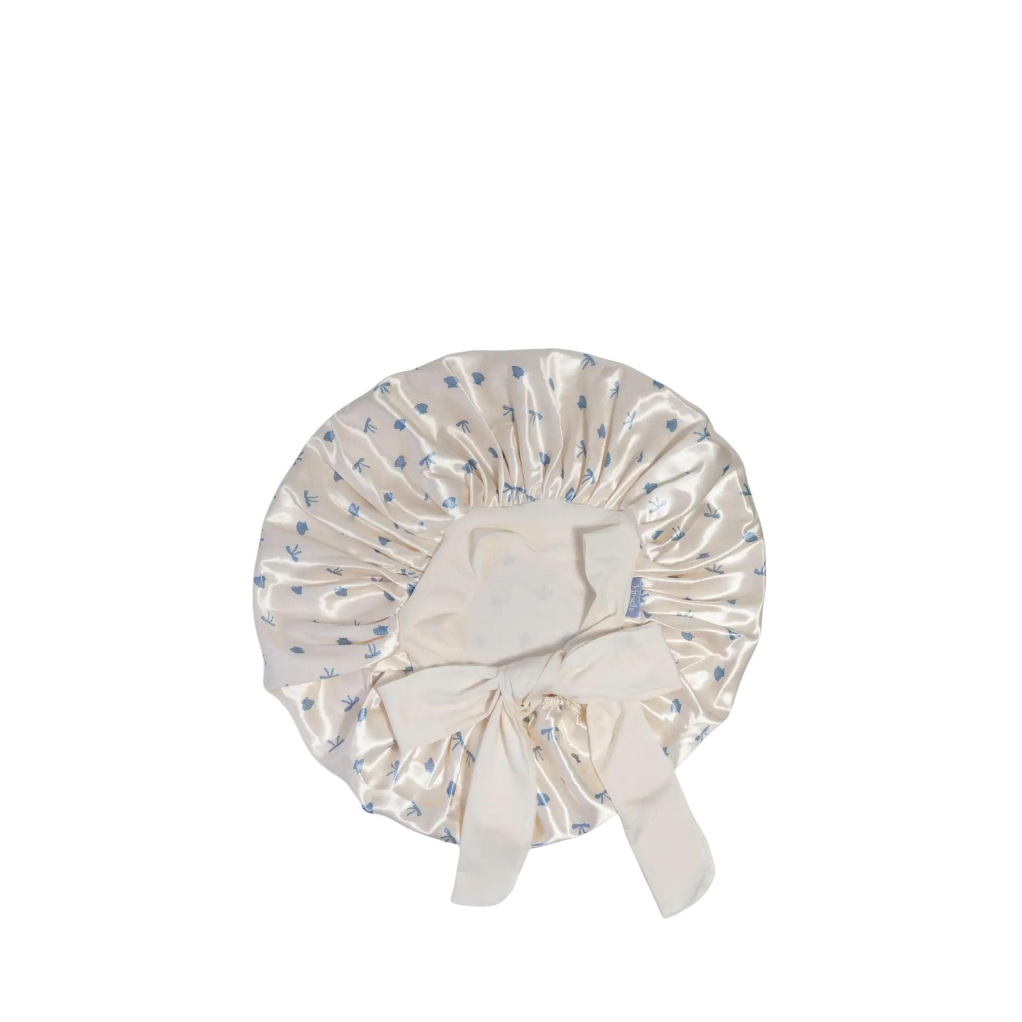 White shower cap with blue floral pattern on a white background
