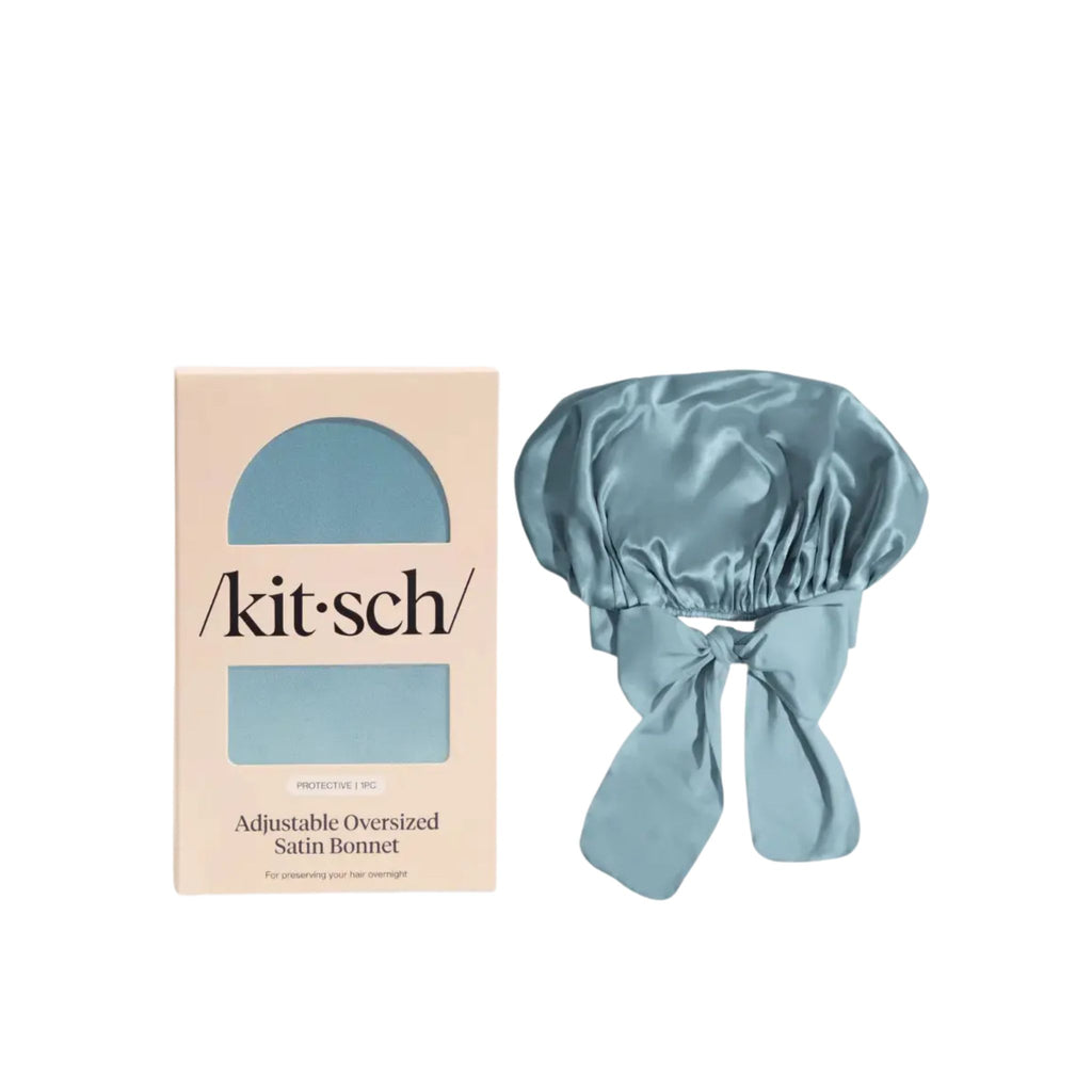 Blue satin bonnet with 'kitsch' packaging on a white background