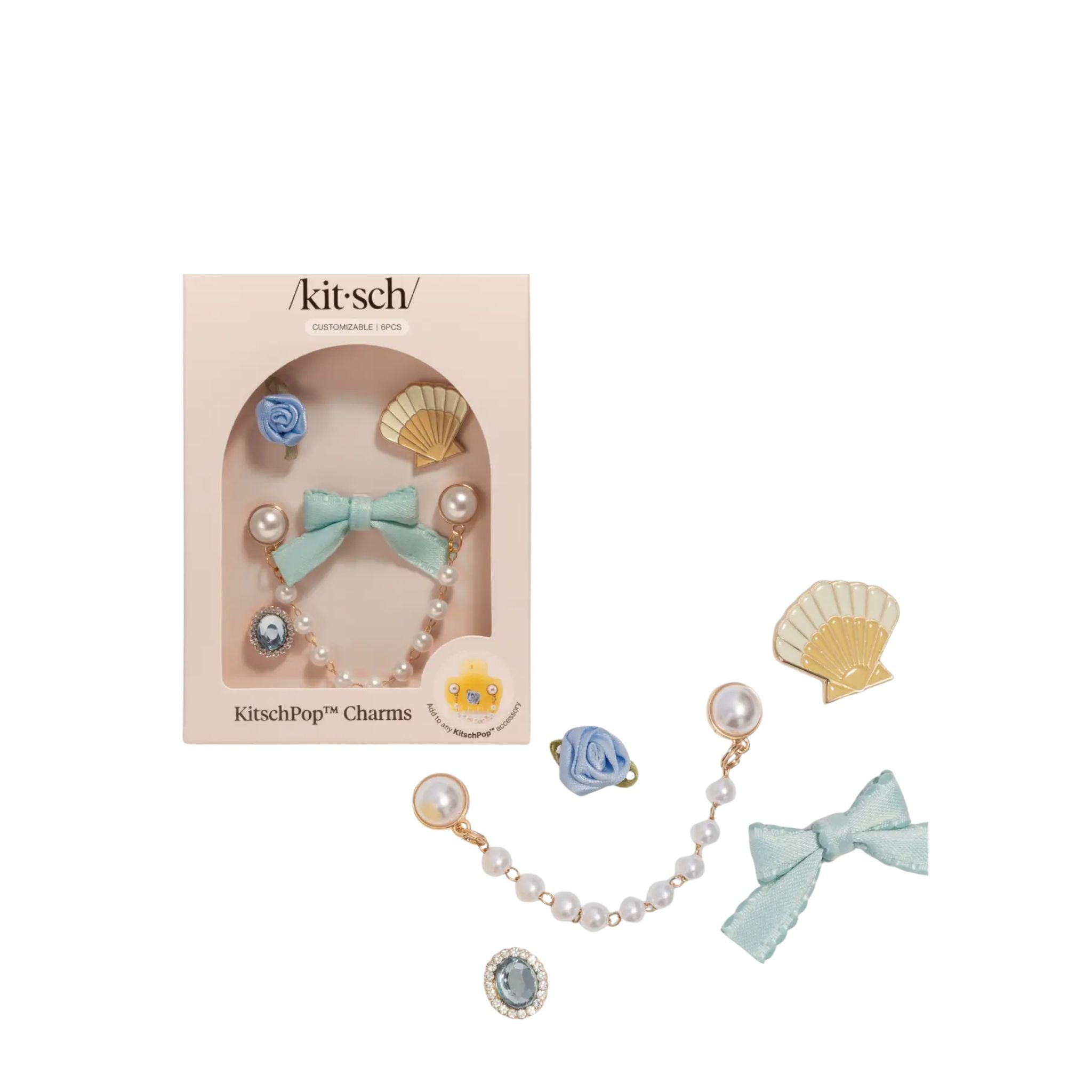 Kitsch charm set with pearls, bows, and seashells on a white background