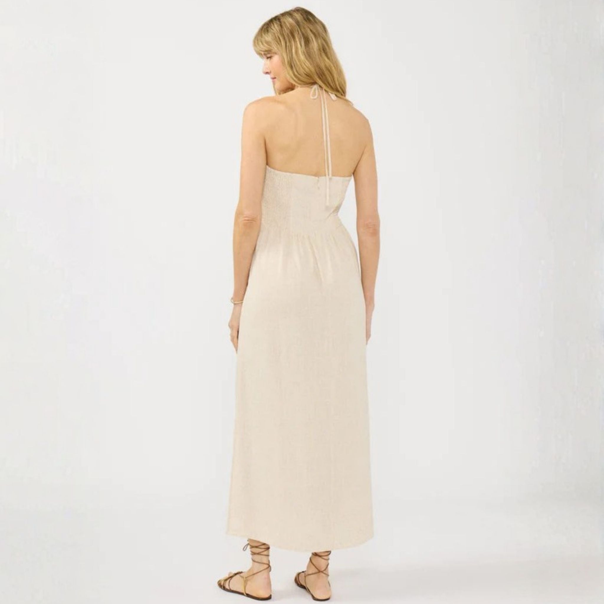 Woman wearing a beige dress on a white background