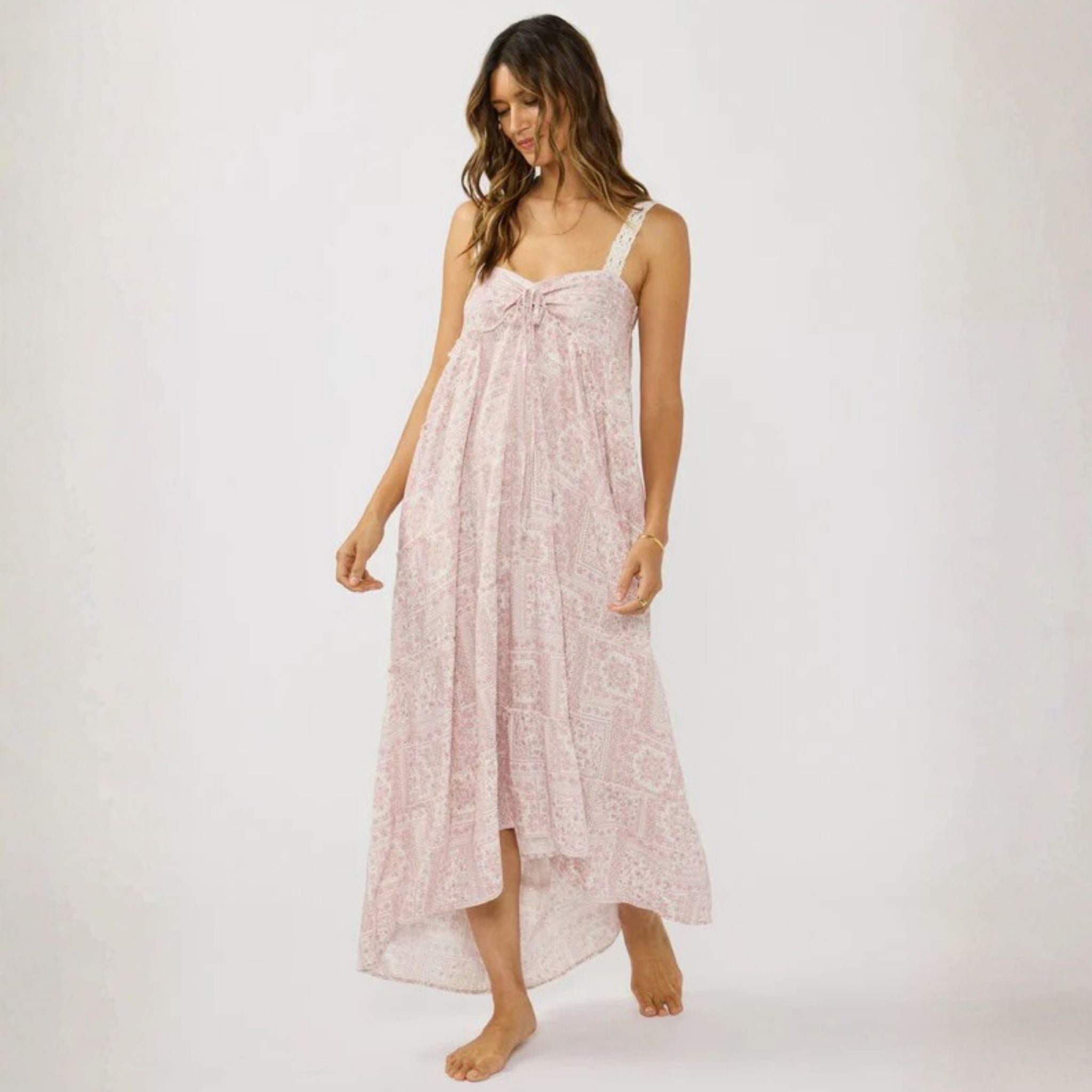 Woman wearing a pink floral dress on a white background