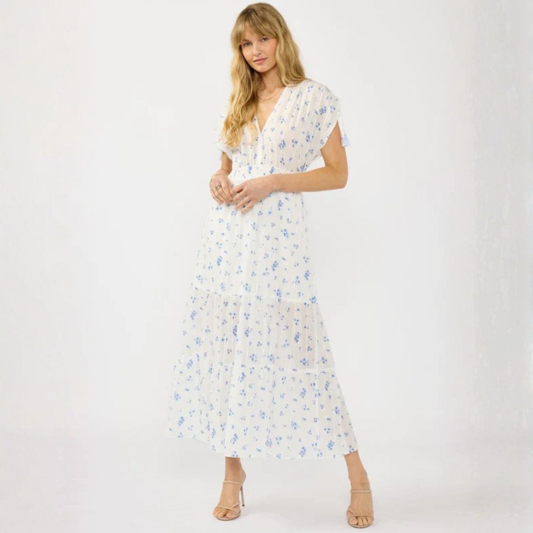 Woman wearing a white floral dress on a white background