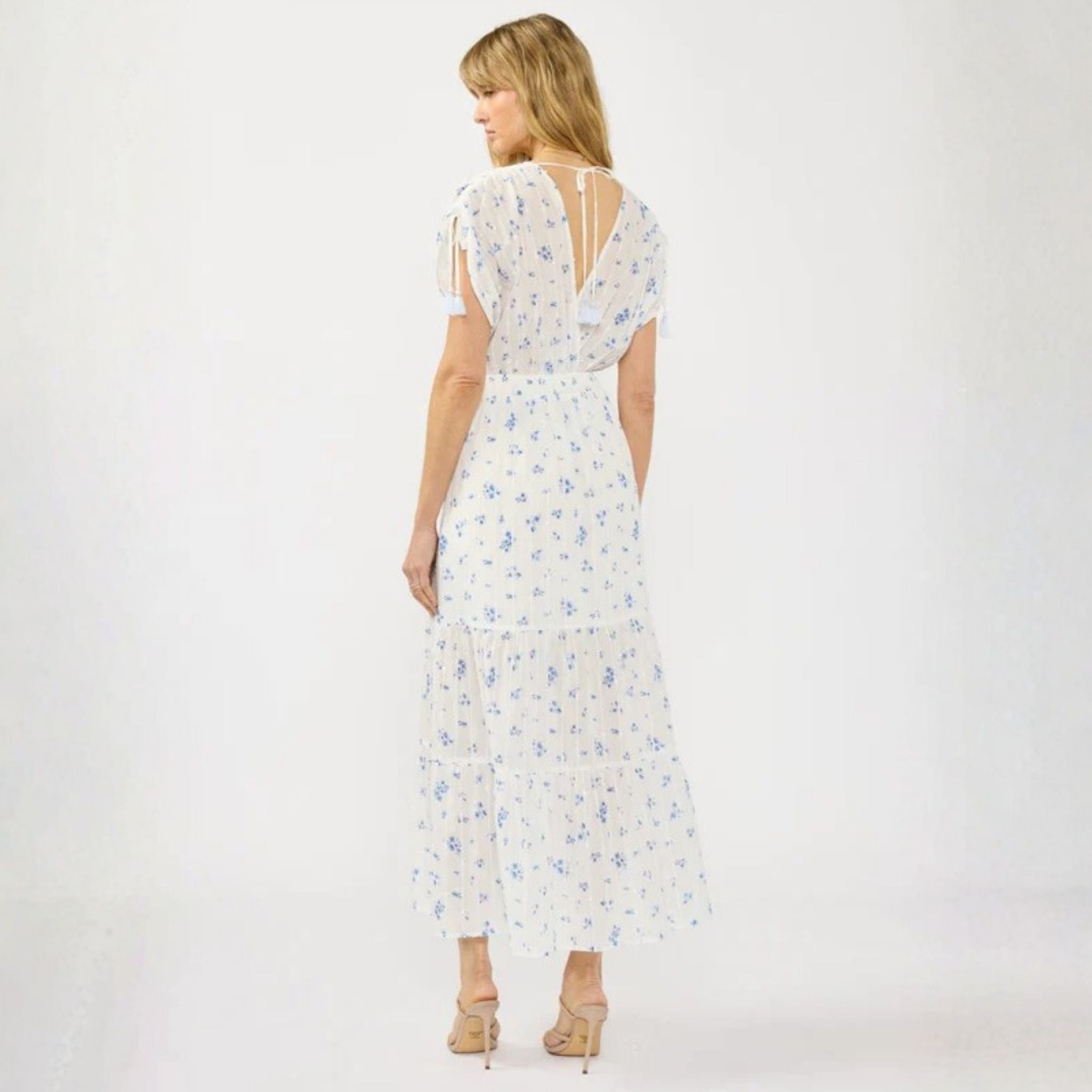 Woman wearing a white floral dress on a white background