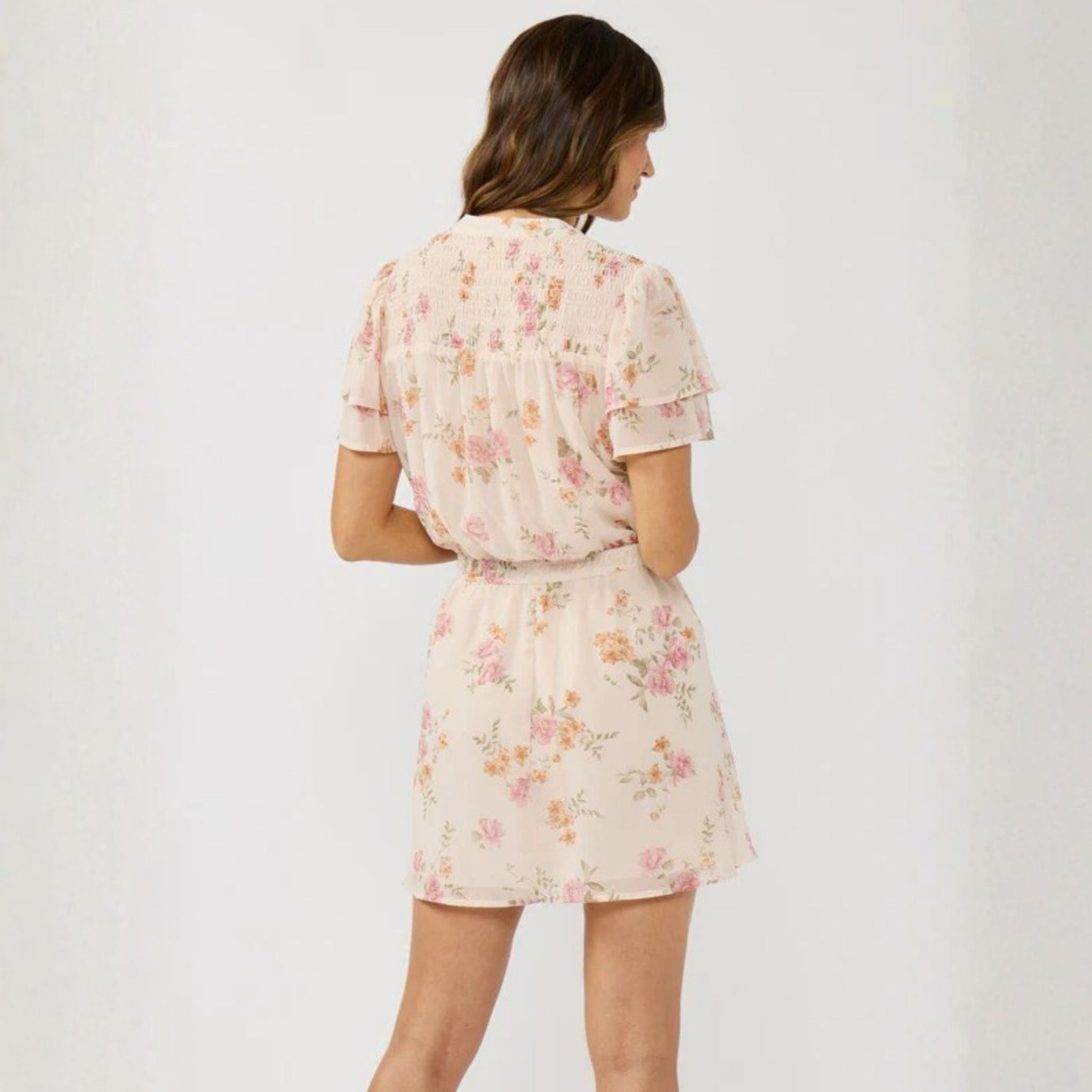 Woman wearing a floral dress on a white background