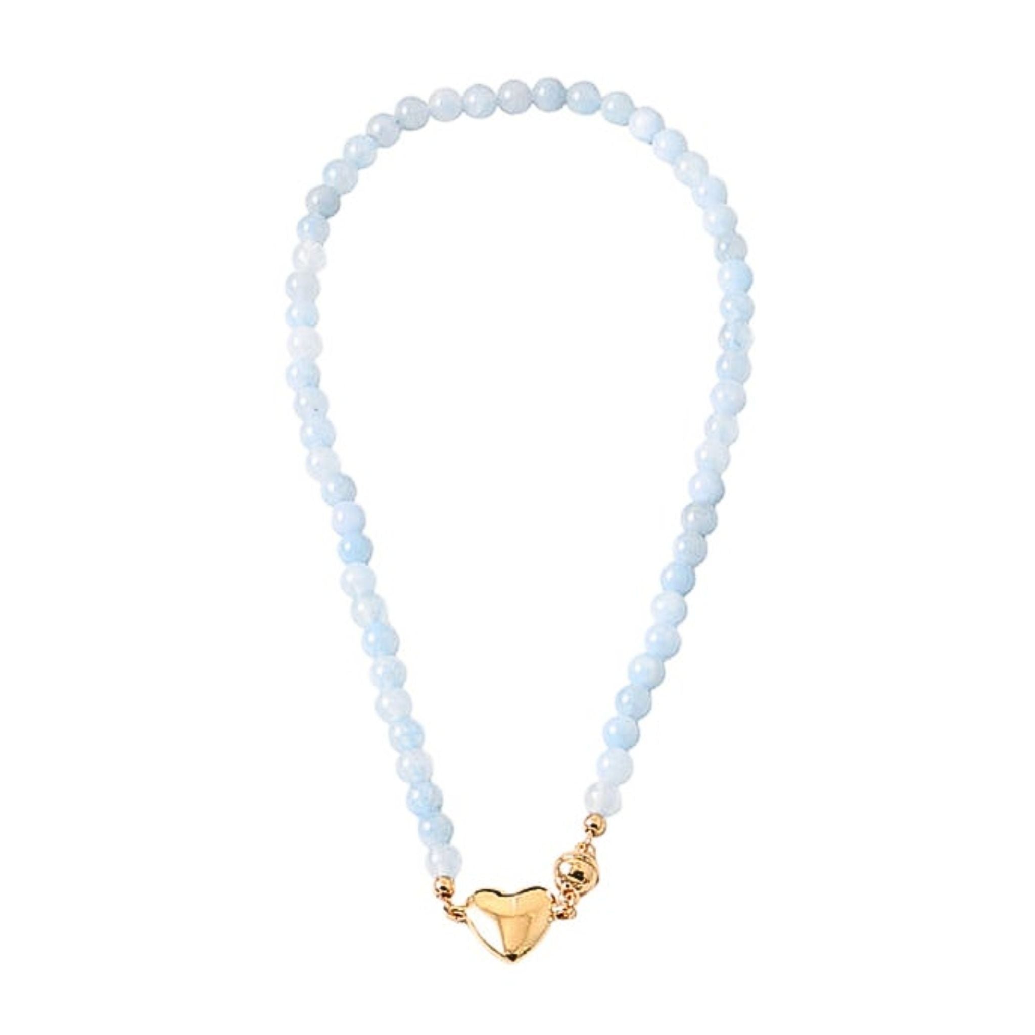 Necklace with light blue beads and a gold heart charm on a white background