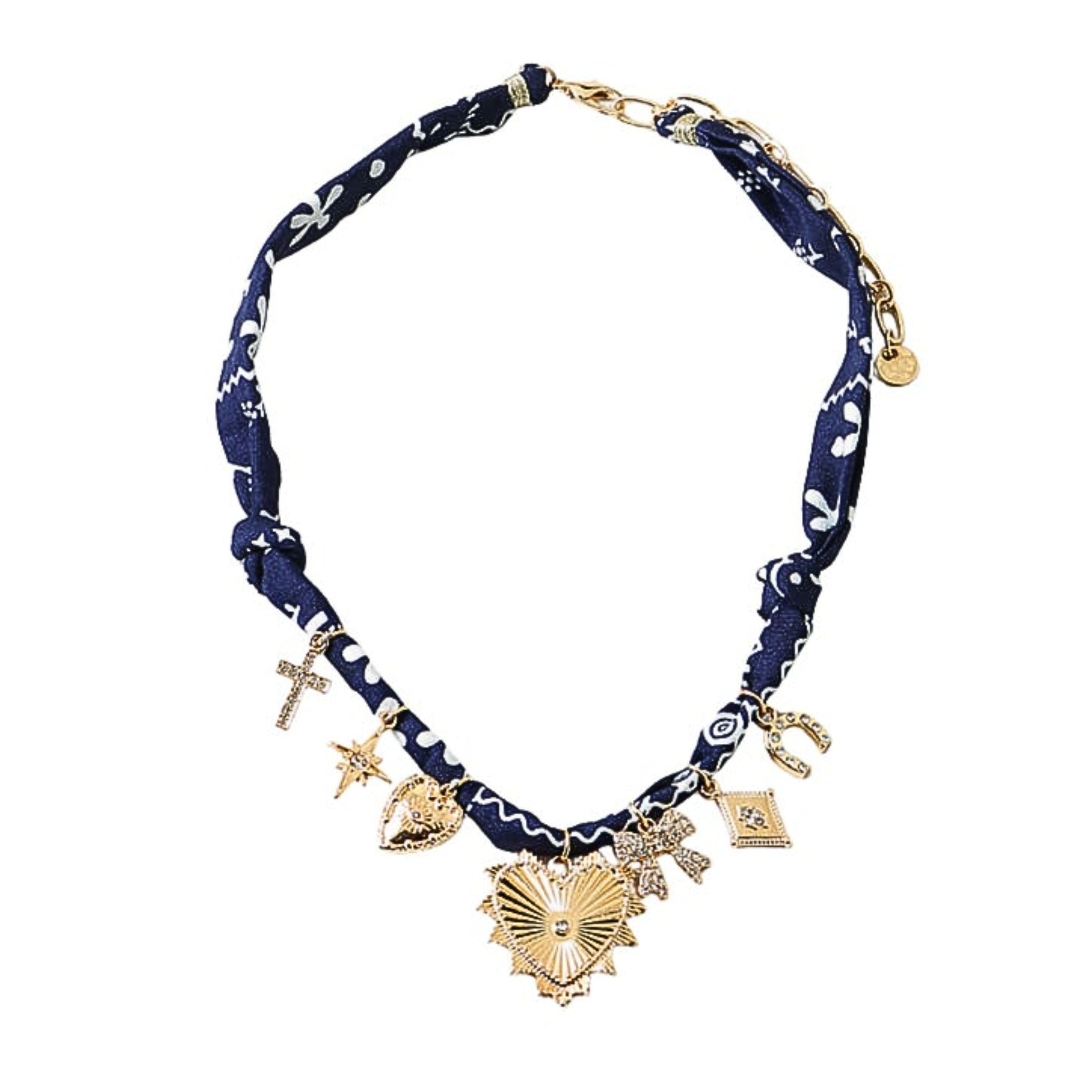 Navy blue fabric necklace with gold charms on a white background