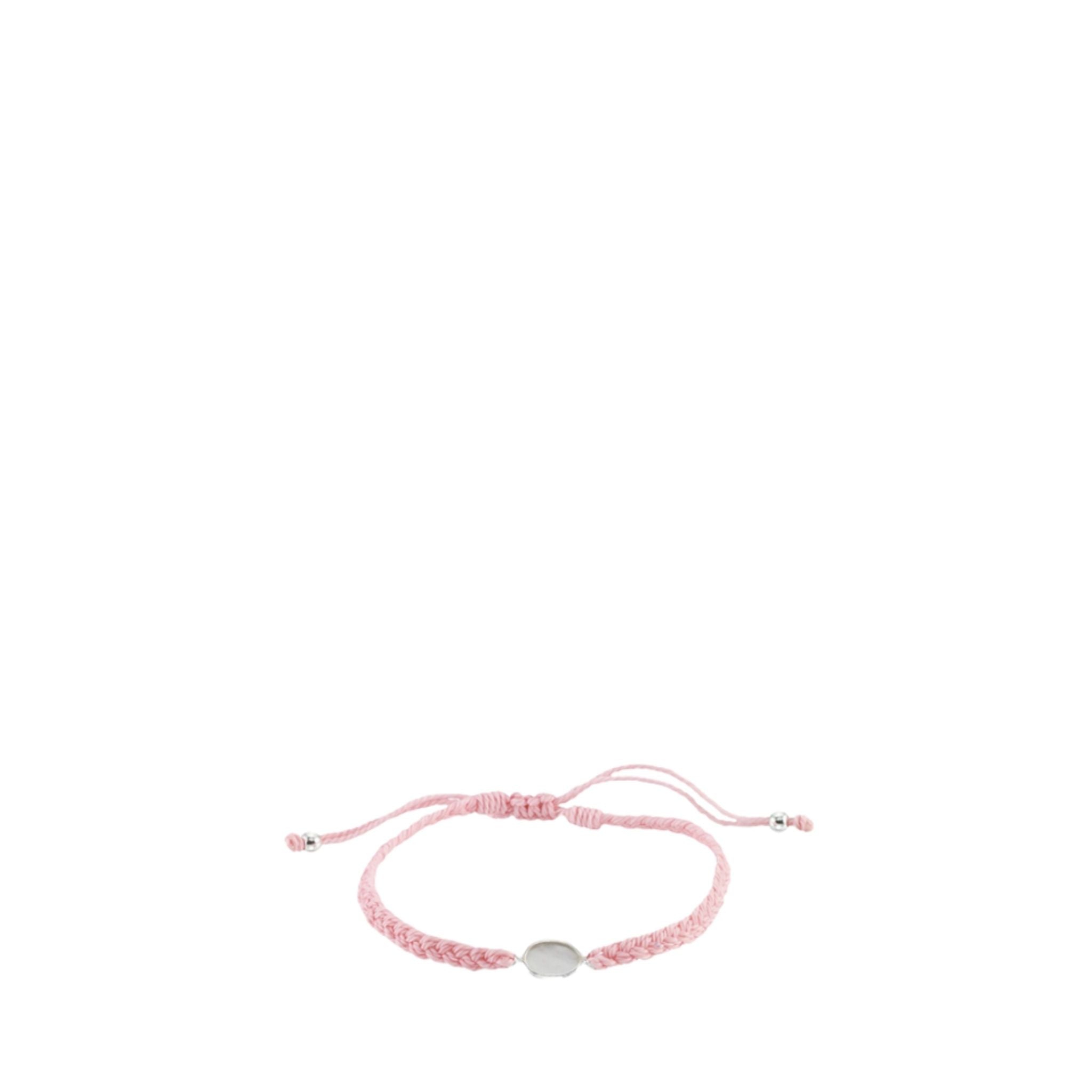 Pink braided bracelet with a silver charm on a white background