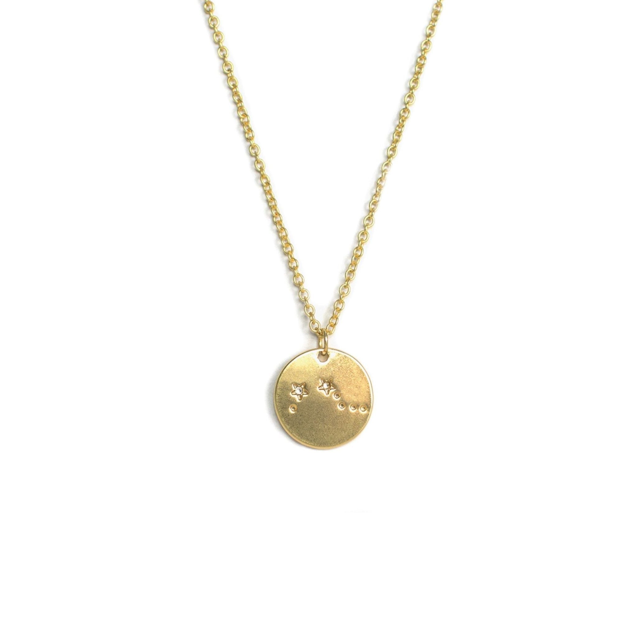 Gold necklace with a round pendant on a white background