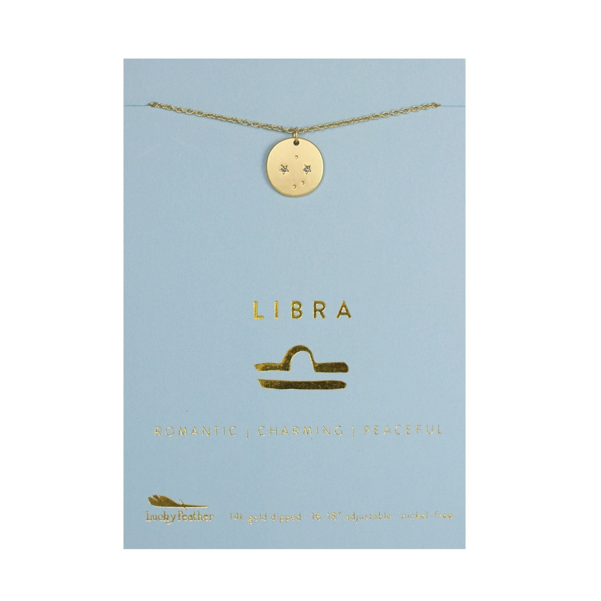 Gold Libra necklace on a blue card with zodiac symbols